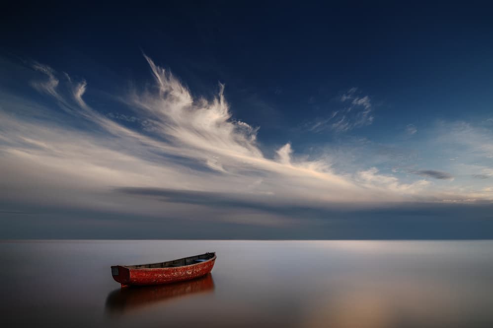 Red Boat Stillness by Kaspars Kurcens — canvas wall art