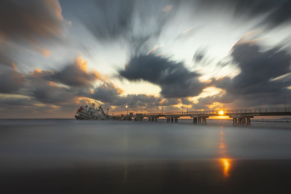 Golden Hour Shipwreck Pier by Andrea Lorenzetti — canvas wall art