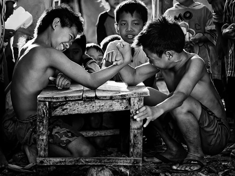Boys Arm Wrestling Fun by Adhi Prayoga — canvas wall art