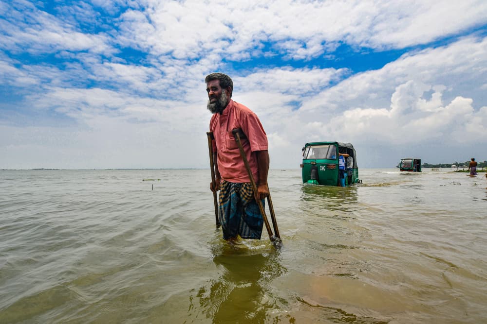 Man Wades Floodwaters by Farhan Labib — canvas wall art