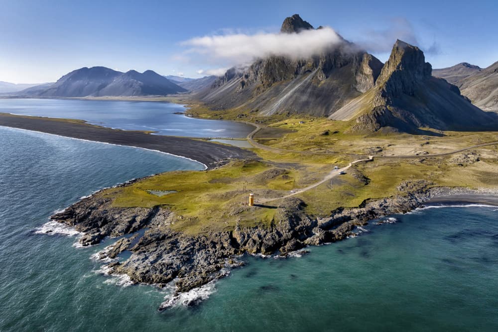 Lighthouse On Rugged Coast by Þorsteinn H. Ingibergsson — canvas wall art