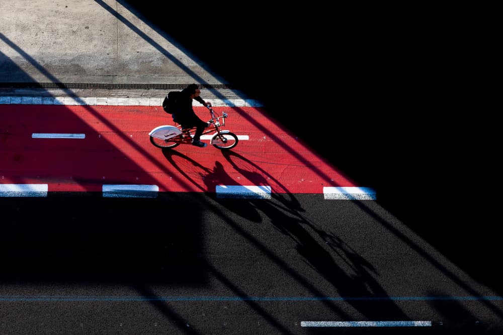 Red Lane Cyclist Shadow by Gloria Staffa — canvas wall art
