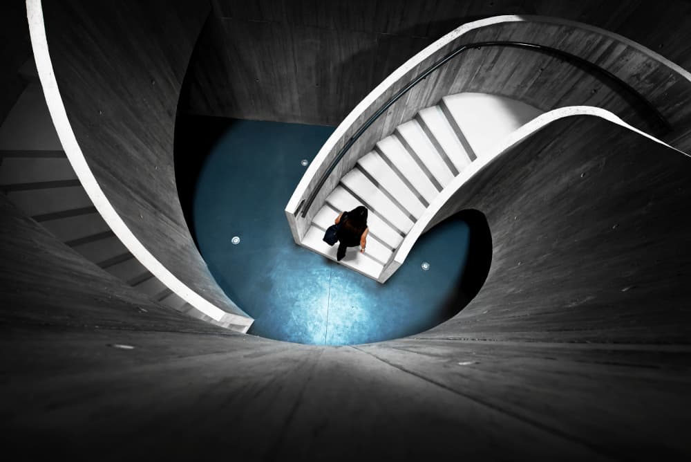 Person Descending Spiral Stairs by Jorge Pimenta — canvas wall art
