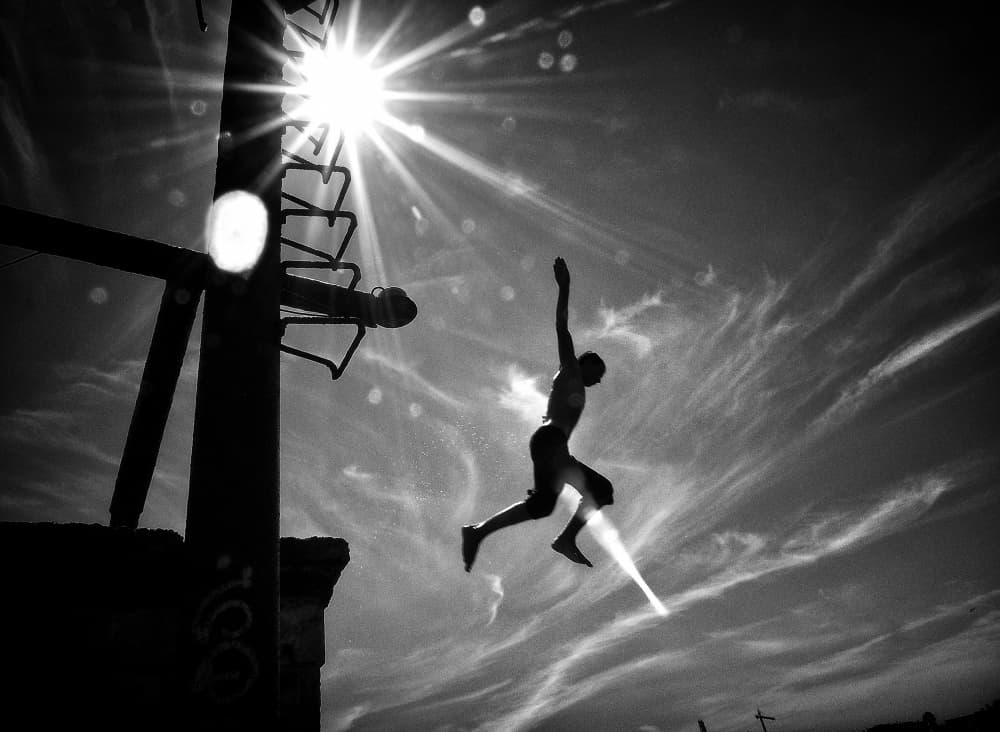 Freedom Leap Against Sun by Mirela Momanu — canvas wall art