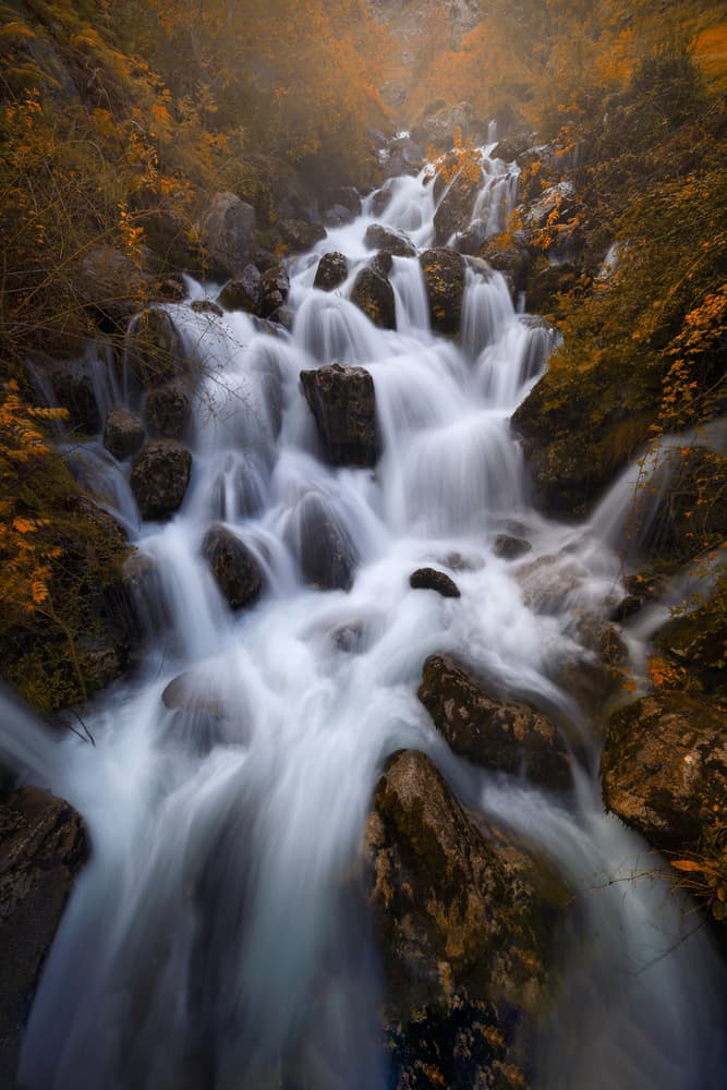 Serene Autumn Waterfall by Juan I. Cuadrado — canvas wall art