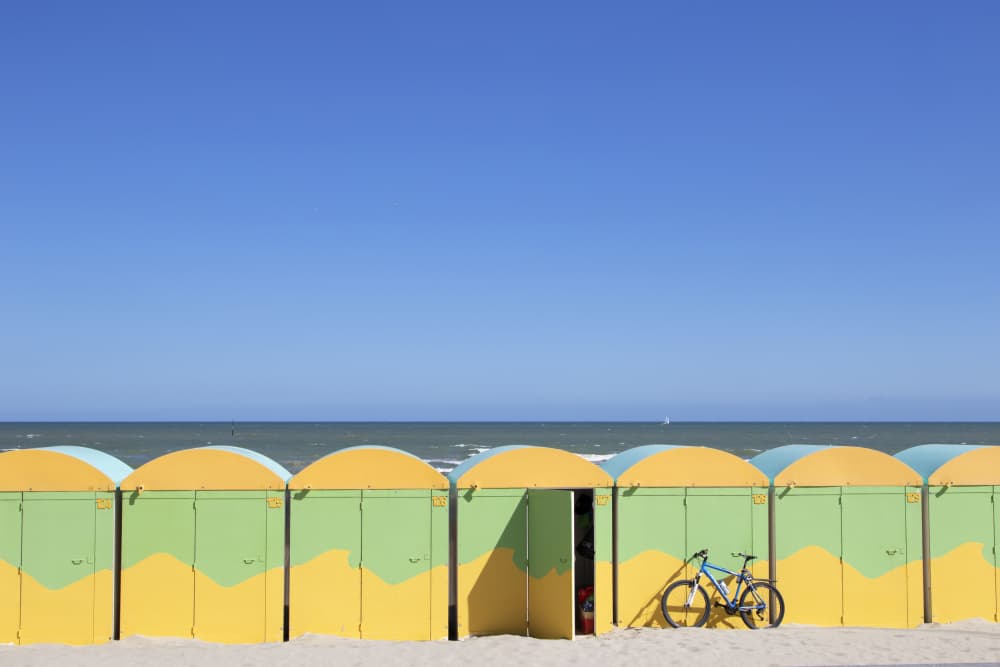 Coastal Huts and Bicycle by Massimo Della Latta — canvas wall art