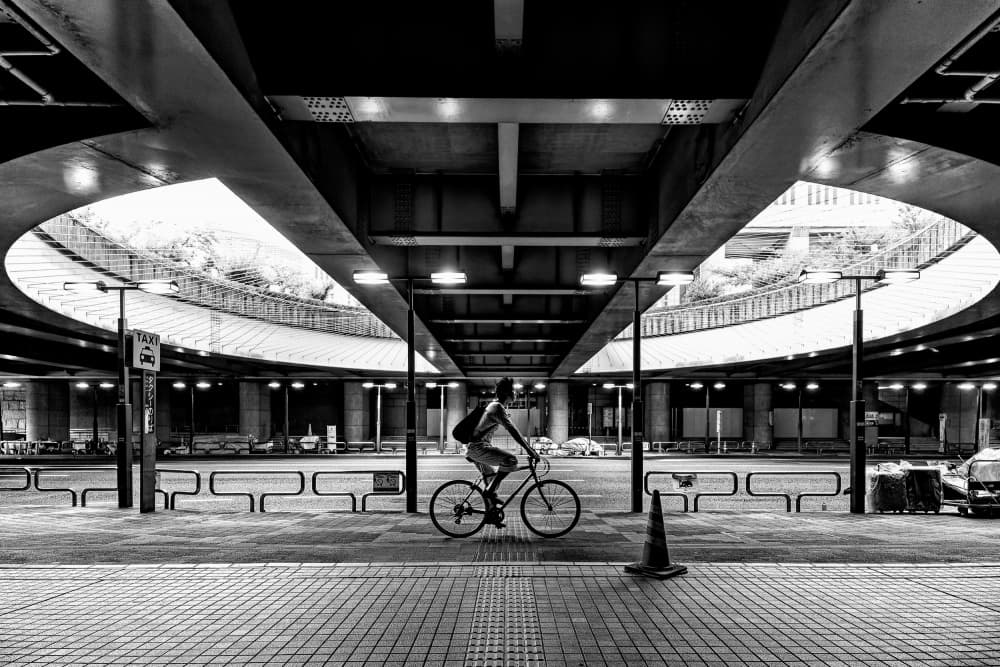 Lone Cyclist Under Bridge by Yuzo Fujii — canvas wall art
