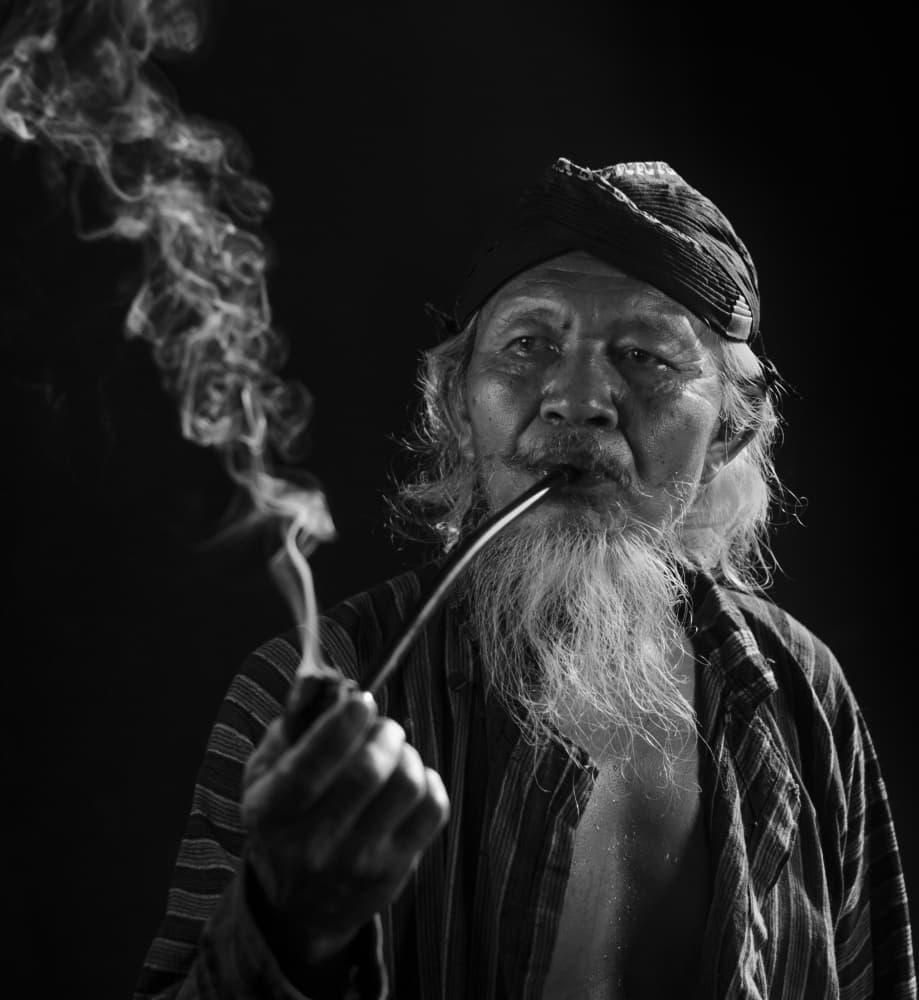 Wise Elder Smoking Pipe by Rawisyah Aditya — canvas wall art