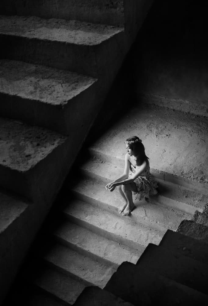 Thoughtful Woman on Stairs by Sebastian Kisworo — canvas wall art