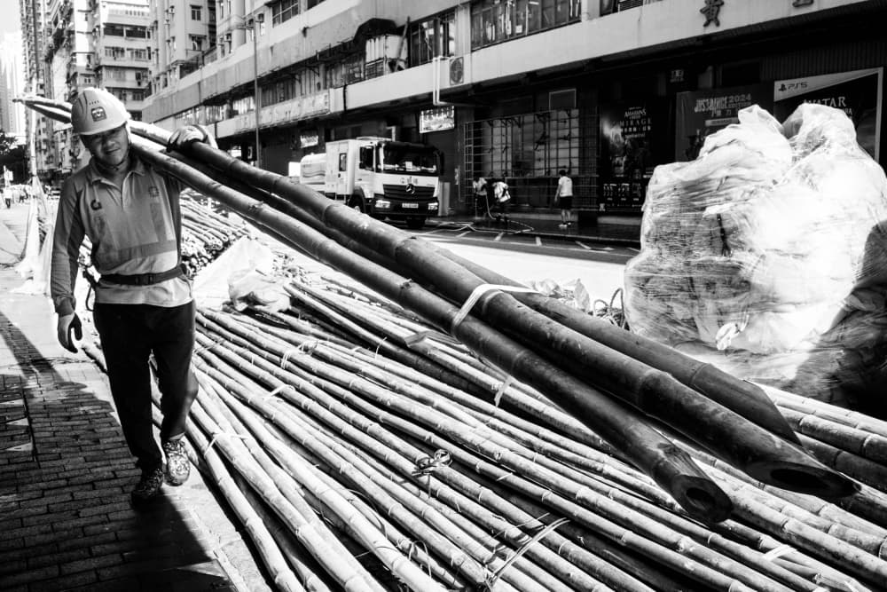 Man Carrying Bamboo Poles by Craig Meakin — canvas wall art