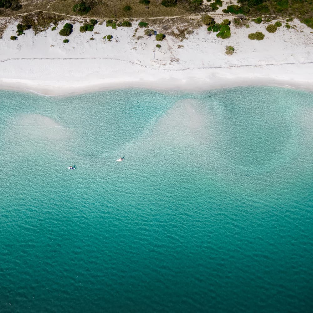 Pristine Beach Paddleboarding by Anna Kirchner — canvas wall art