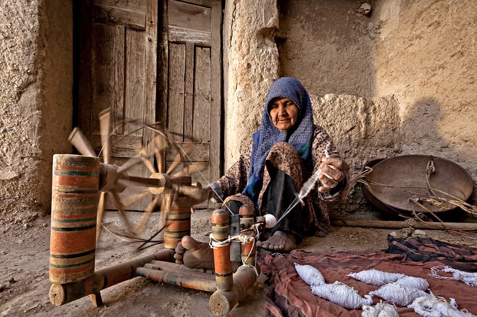 Old Woman Spinning Wool by Mohammadreza Momeni — canvas wall art