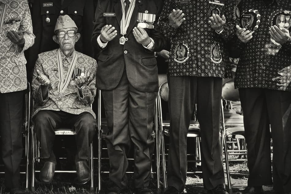 Veterans In Solemn Prayer by Firman Maulana — canvas wall art