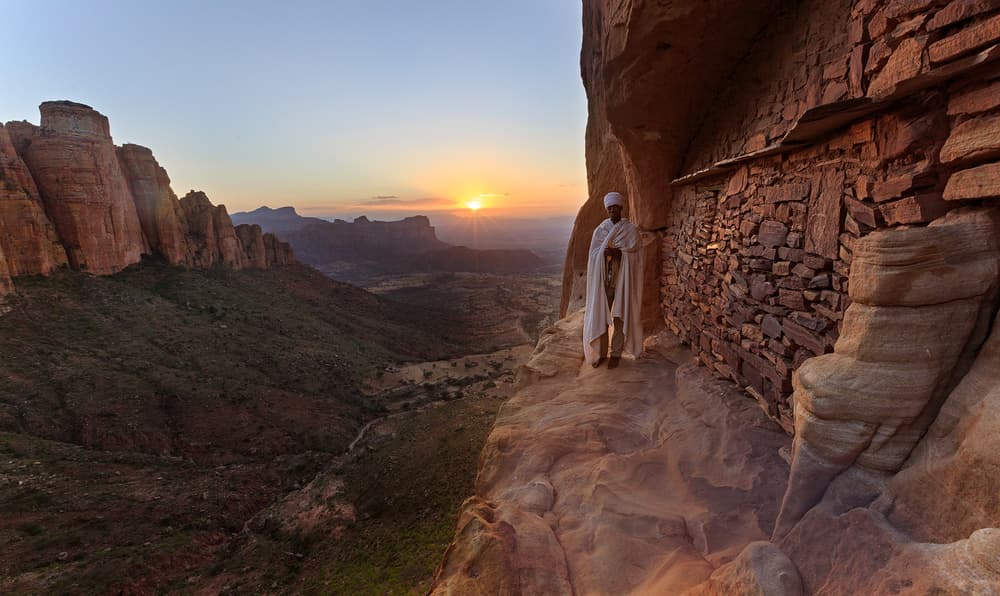 Ethiopian Monk on Cliffside by Greg Metro — canvas wall art