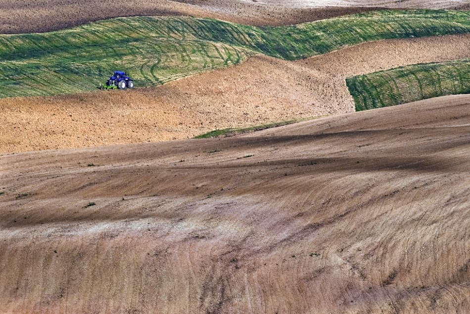 Tractor in Rolling Fields by Jure Kravanja — canvas wall art
