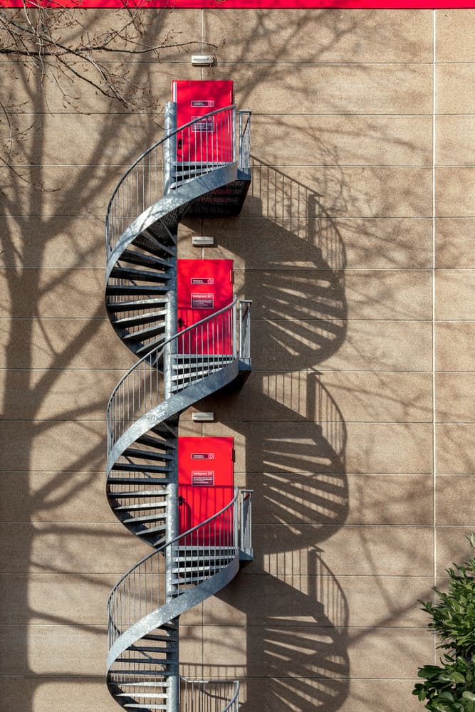 Red Doors Spiral Ascent by Theo Luycx — canvas wall art