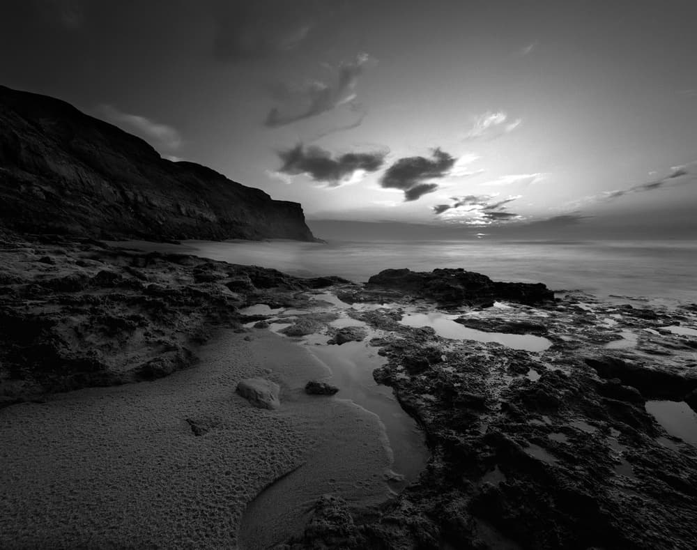 Serene Rocky Coast by Nana Sousa Dias — canvas wall art
