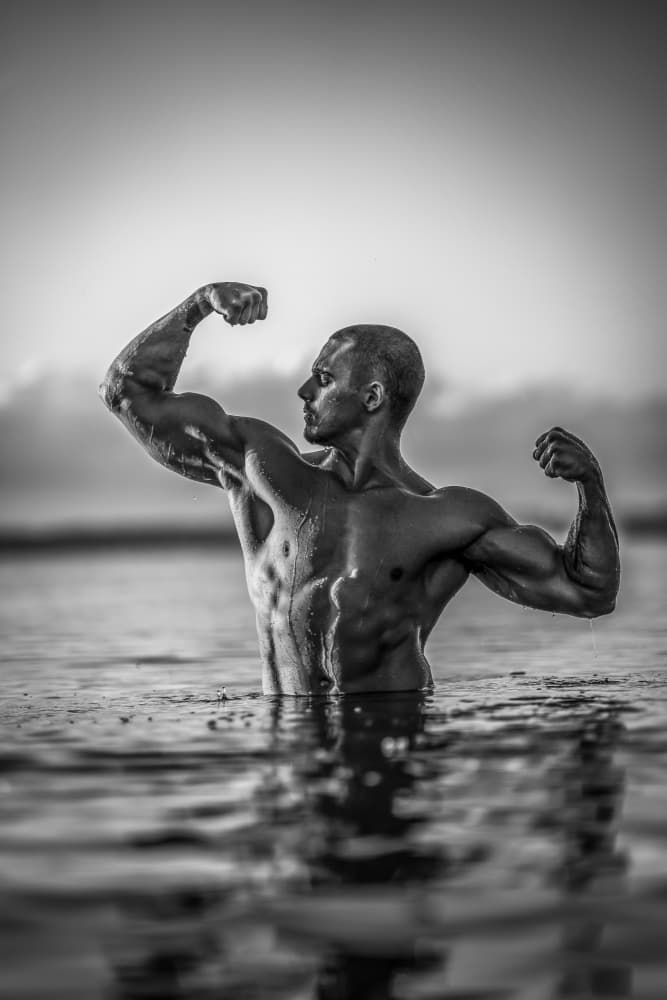 Flexing Bodybuilder In Water by James Graf — canvas wall art