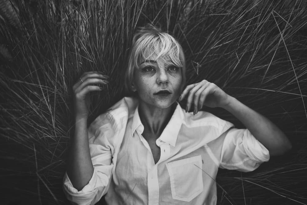 Pensive Woman in Grass by Yuri Shepelev — canvas wall art