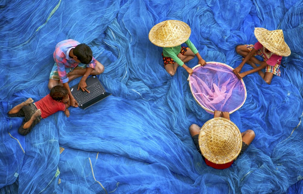 Kids Learning on Blue Nets by Ajit Kumar Majhi — canvas wall art