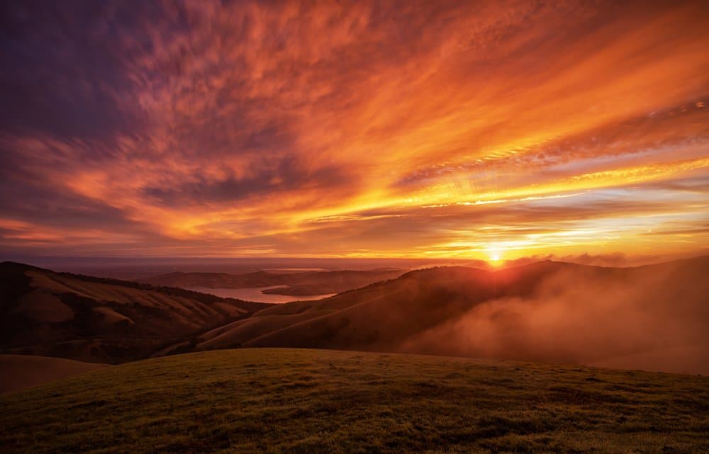 Vibrant Sunset Over Hills by Jenny Qiu — canvas wall art