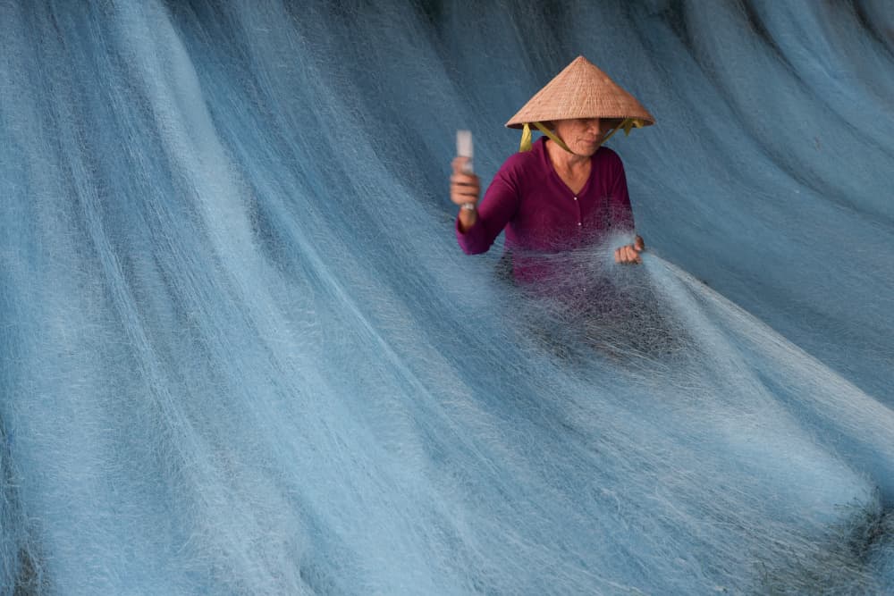 Woman Mending Blue Nets by Clas Gustafson PRO — canvas wall art