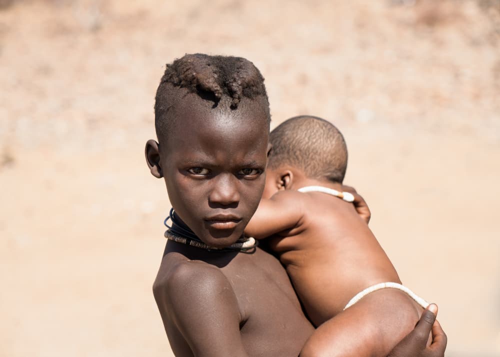 African Child Carrying Baby by Willa Wei — canvas wall art