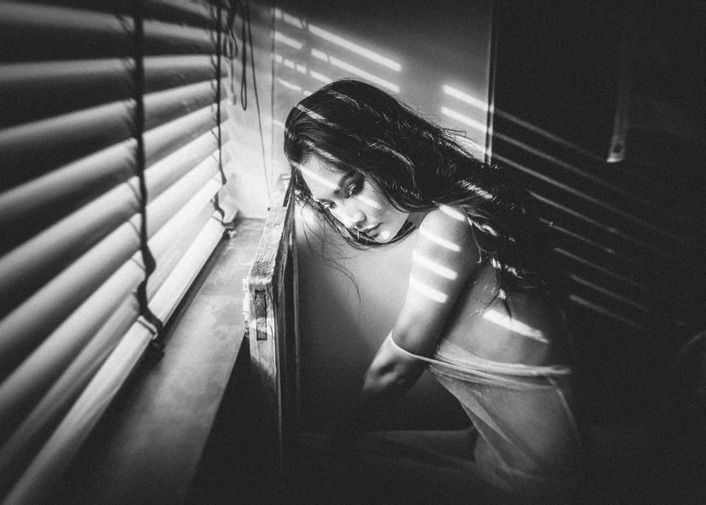 Moody Woman by Window by ADIREK M — canvas wall art