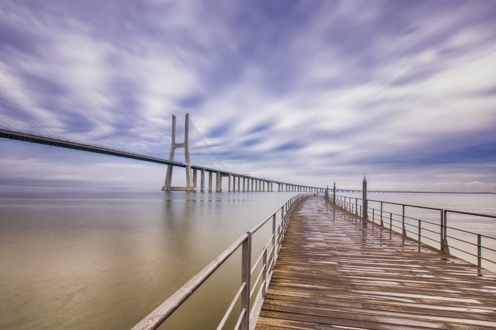Long Bridge Calm Water by JUAN CARLOS HERVÁS MARTÍNEZ — canvas wall art