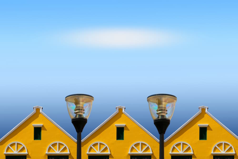 Yellow Houses Blue Sky by Hans-Wolfgang Hawerkamp — canvas wall art