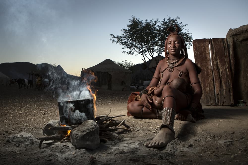 Himba Mother by Fire by Ben McRae — canvas wall art