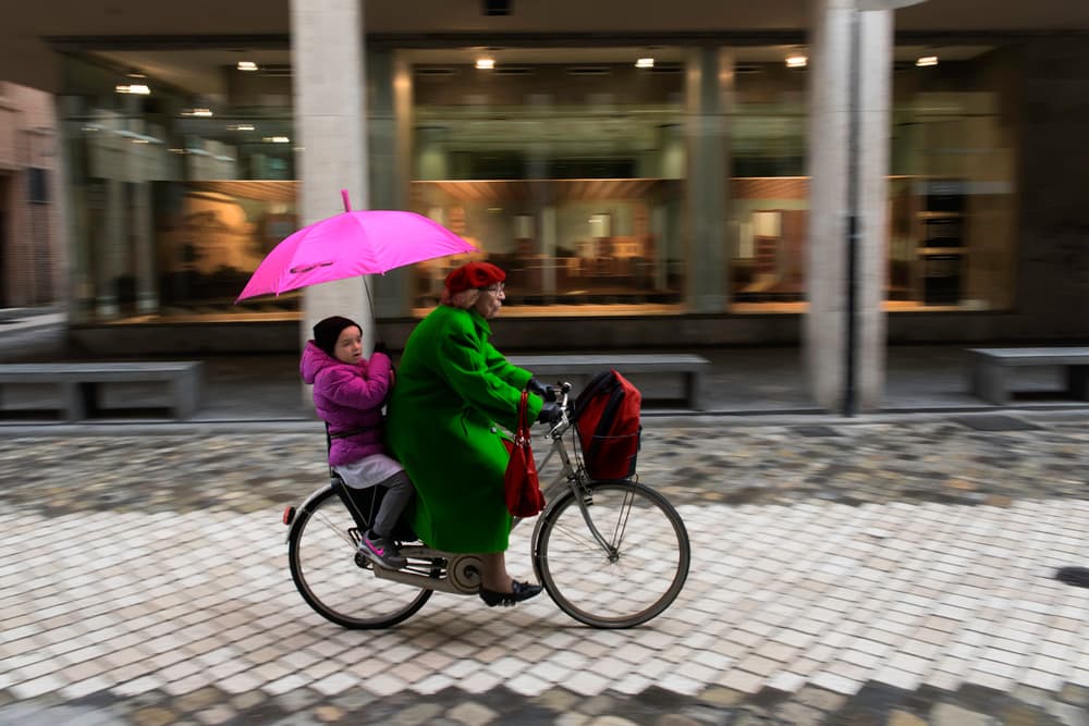 Pink Umbrella Bike Ride by Luca Domenichi — canvas wall art