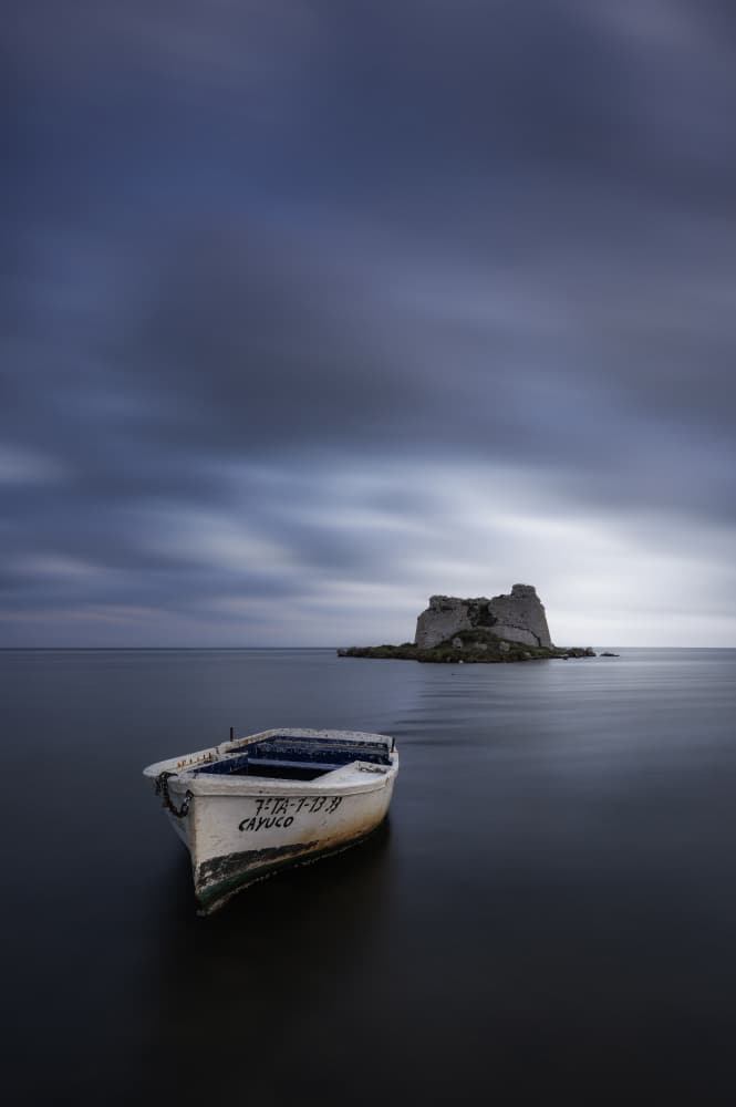 Lonely Boat Distant Island by Jorge Ruiz Dueso — canvas wall art