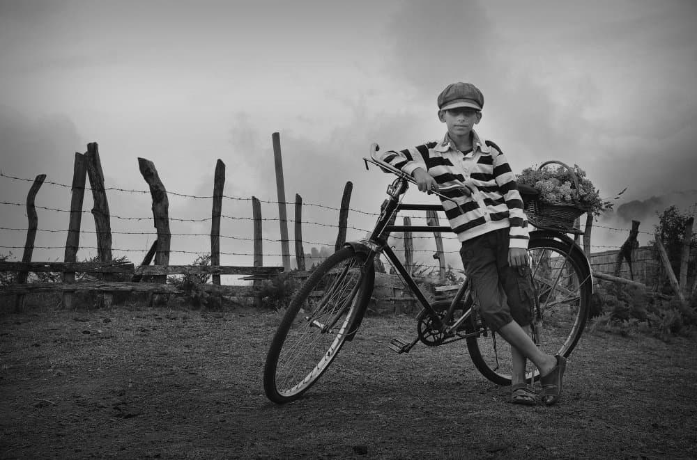 Boy On Bicycle by Benyamin Riahy — canvas wall art