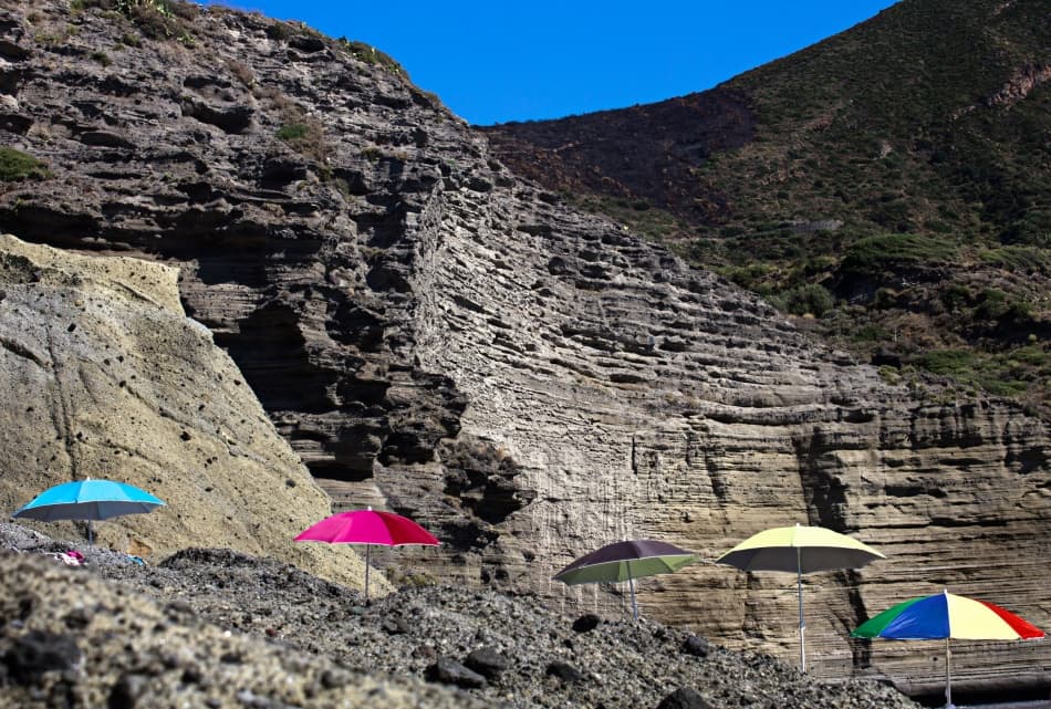 Colorful Umbrellas Rocky Beach by Lorenzo Grifantini — canvas wall art