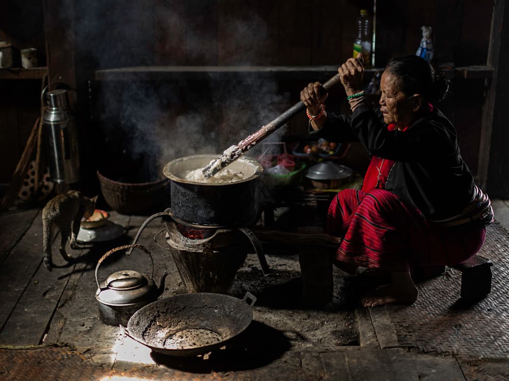 Woman Cooking Rustic Meal by Amnon Eichelberg — canvas wall art