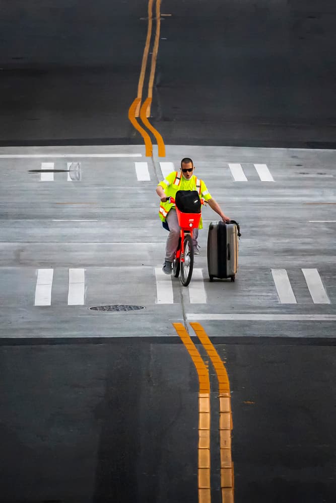 Man on Bike with Suitcase by Fion Wong — canvas wall art
