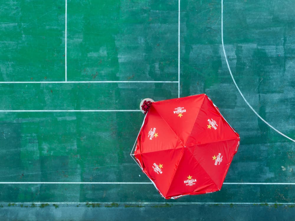 Red Umbrella Green Court by Jure Kravanja — canvas wall art