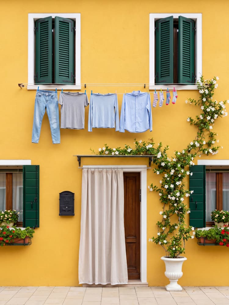 Yellow House Laundry Day by Andreas Magnusson — canvas wall art