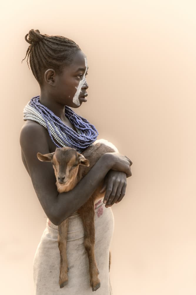 African Child Holding Goat by Trevor Cole — canvas wall art