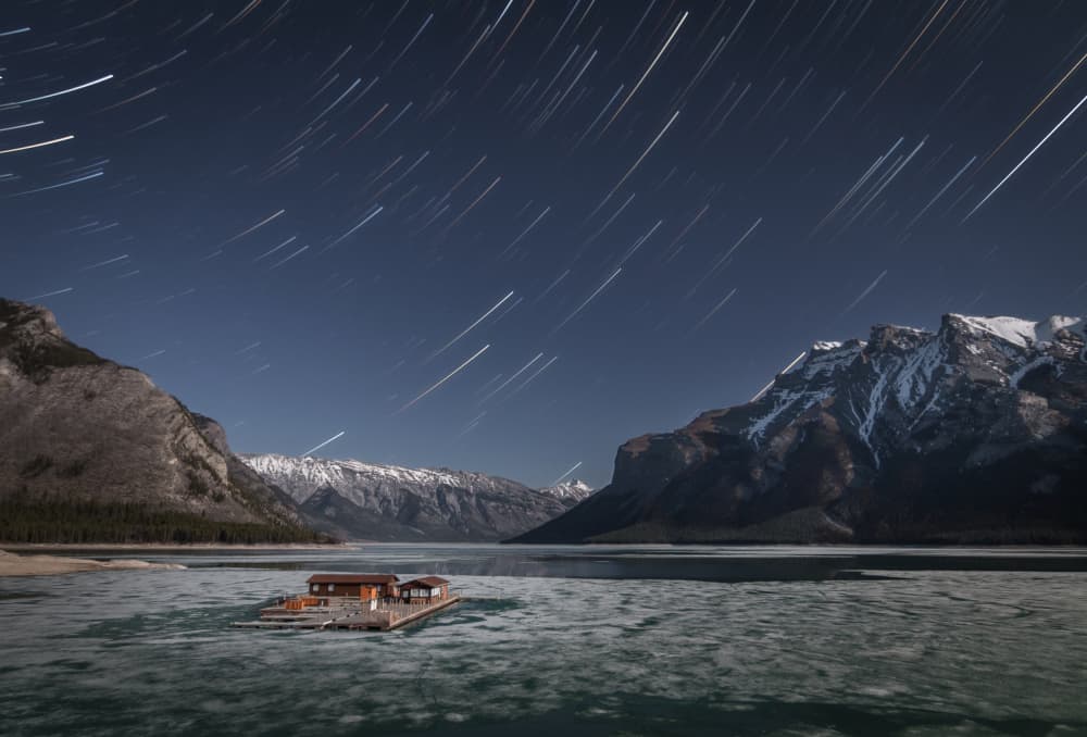 Star Trails Over Frozen Lake by Christoph Schaarschmidt — canvas wall art