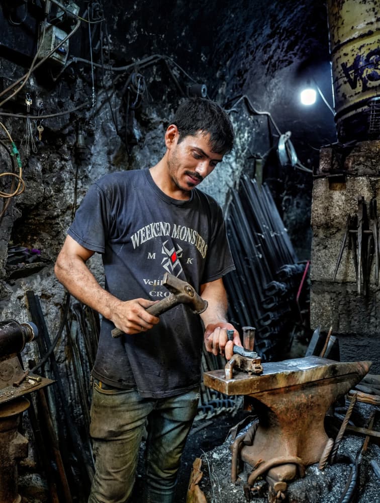 Focused Metal Worker by Bashar Alsofey — canvas wall art
