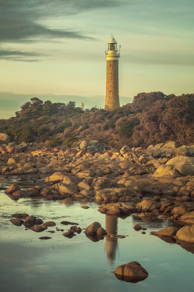 Serene Lighthouse Reflection by Christopher Perez Liedl — canvas wall art