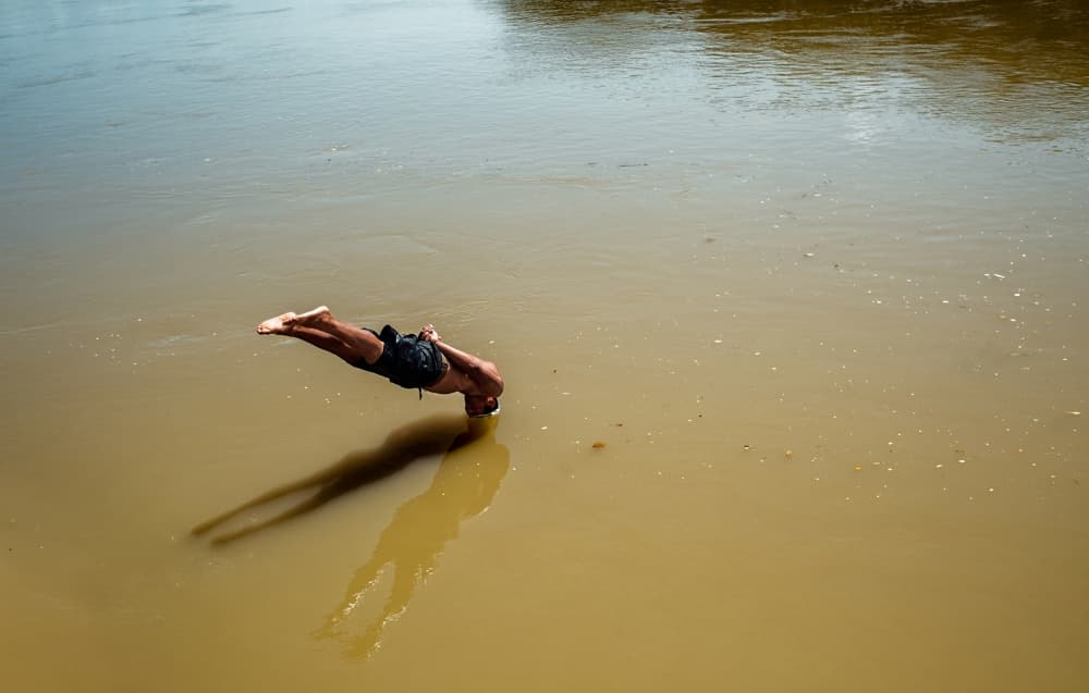 Man Diving Serene Water by PAUL GOMEZ — canvas wall art