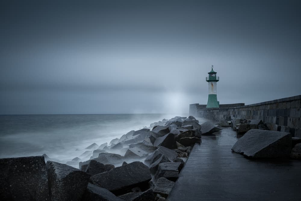 Foggy Lighthouse Pier by Radek Pohnan — canvas wall art