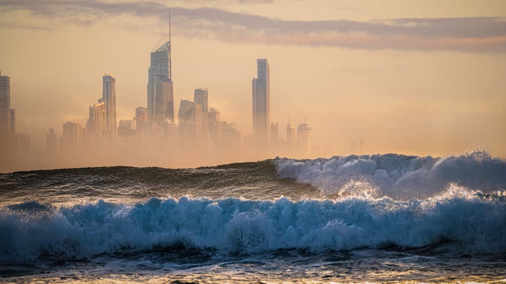 Misty Coastal City Waves by Emanuel Papamanolis — canvas wall art