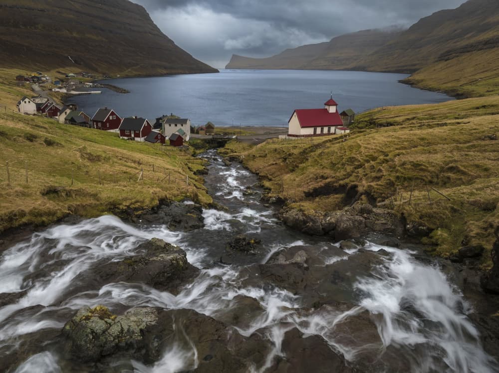 Remote Fjord Village Stream by Jure Kravanja — canvas wall art