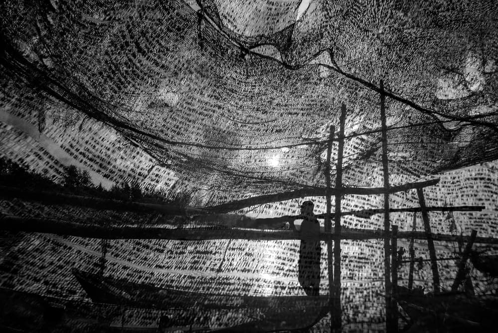 Man Beneath Fishing Nets by Ekkachai Khemkum — canvas wall art