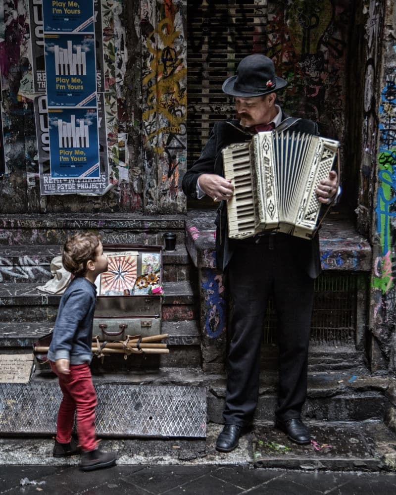 Boy Watches Street Music by Vince Russell — canvas wall art