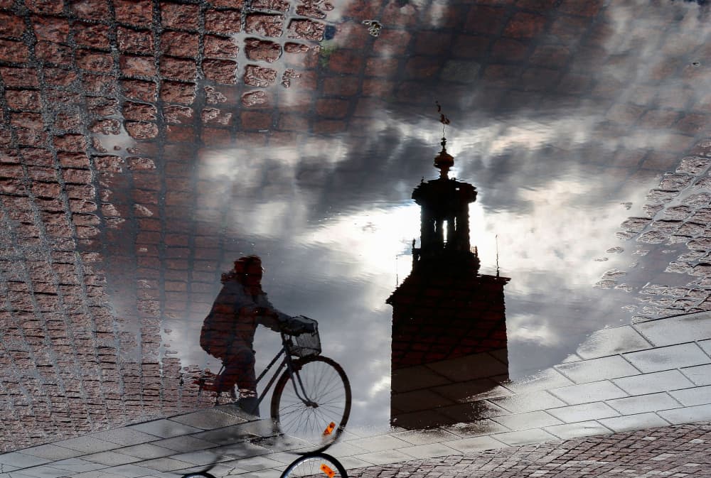 Cyclist Puddle Reflection by Karim Al Thahaby — canvas wall art